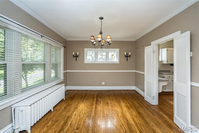 7041 Northmoor Dr, University City, MO 63105 - unfurnished room with radiator heating unit, a chandelier, light wood finished floors, and crown molding