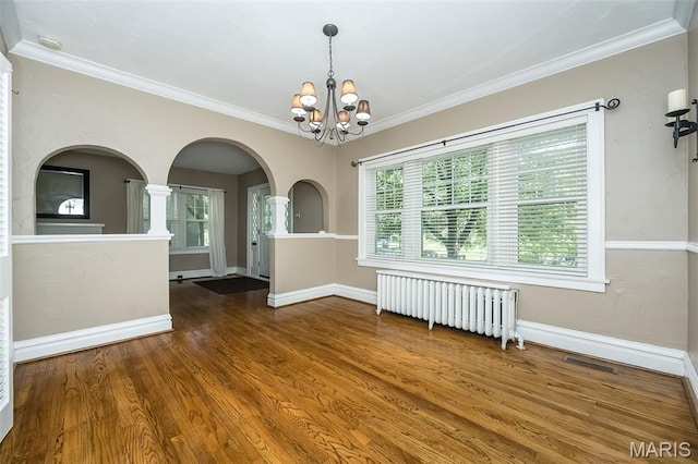 7041 Northmoor Dr, University City, MO 63105 - unfurnished room featuring radiator heating unit, a chandelier, arched walkways, wood finished floors, and ornamental molding