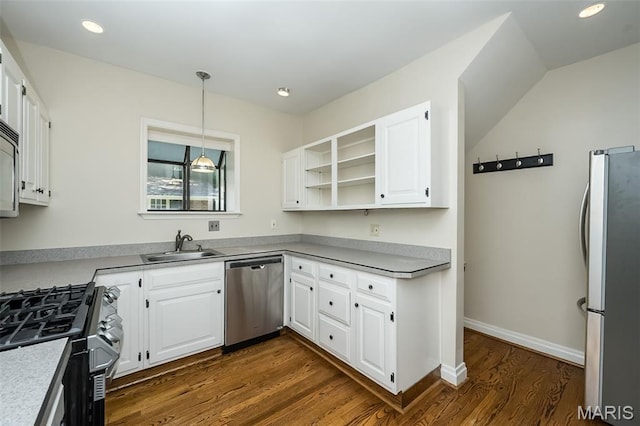 7041 Northmoor Dr, University City, MO 63105 - kitchen featuring appliances with stainless steel finishes, dark wood-style flooring, white cabinetry, decorative light fixtures, and recessed lighting