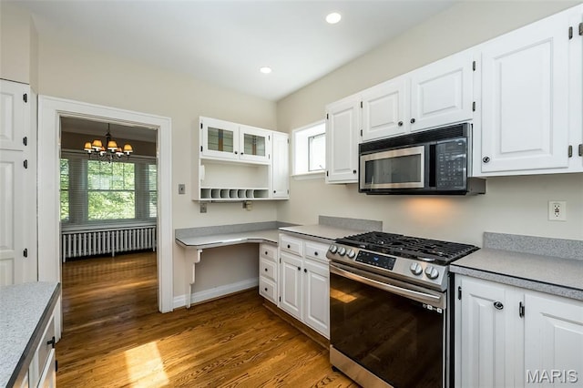 7041 Northmoor Dr, University City, MO 63105 - kitchen featuring black microwave, stainless steel gas range, radiator, a chandelier, and light countertops