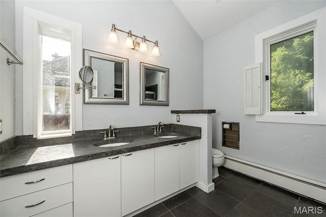 7041 Northmoor Dr, University City, MO 63105 - full bath featuring a baseboard radiator, lofted ceiling, double vanity, and tile patterned flooring