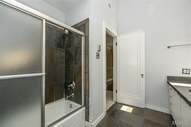 7041 Northmoor Dr, University City, MO 63105 - full bath with vanity, combined bath / shower with glass door, a closet, and stone finish flooring