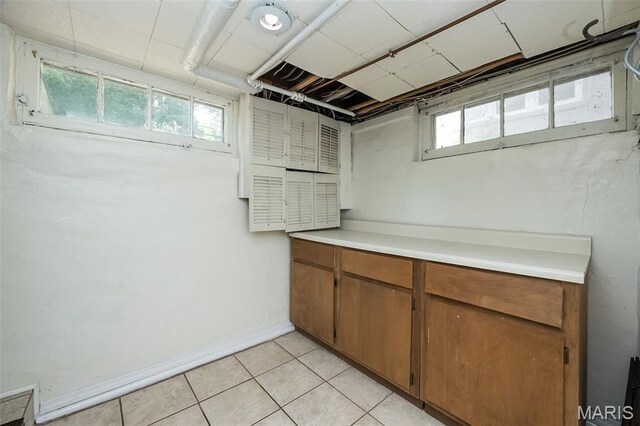 7041 Northmoor Dr, University City, MO 63105 - below grade area featuring light tile patterned flooring