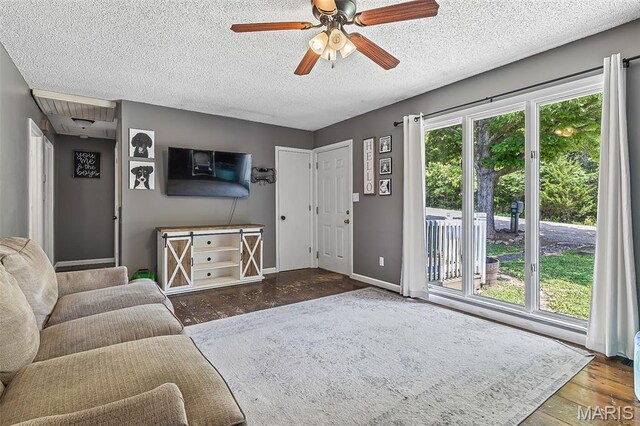 1764 Bourbon Dr, Bonne Terre, MO 63628 - living area with wood finished floors, a textured ceiling, ceiling fan, and baseboards