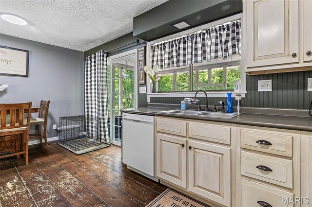 1764 Bourbon Dr, Bonne Terre, MO 63628 - kitchen with dishwasher, a sink, dark countertops, healthy amount of natural light, and a textured ceiling