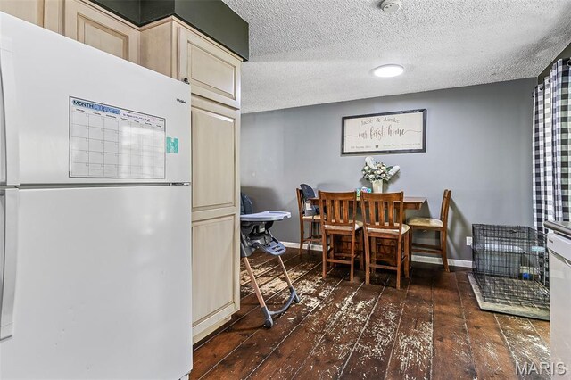 1764 Bourbon Dr, Bonne Terre, MO 63628 - dining room featuring dark wood finished floors, baseboards, and a textured ceiling
