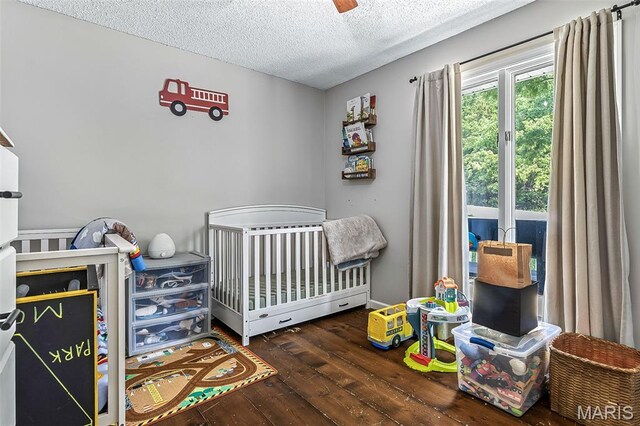 1764 Bourbon Dr, Bonne Terre, MO 63628 - bedroom with hardwood / wood-style flooring, a textured ceiling, and a nursery area
