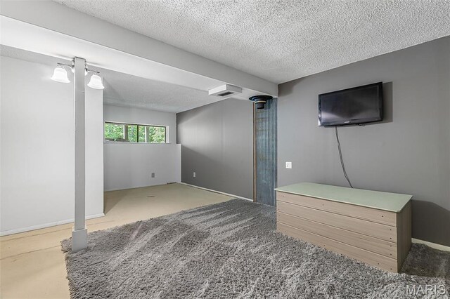 1764 Bourbon Dr, Bonne Terre, MO 63628 - below grade area featuring a textured ceiling, carpet floors, and baseboards
