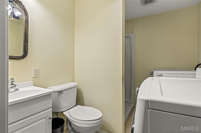 1764 Bourbon Dr, Bonne Terre, MO 63628 - bathroom with vanity, washer and clothes dryer, a shower stall, and toilet