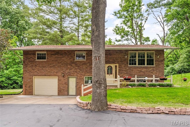 1209 Eiler Rd, Belleville, IL 62223 - bi-level home featuring a garage, driveway, a front lawn, and brick siding