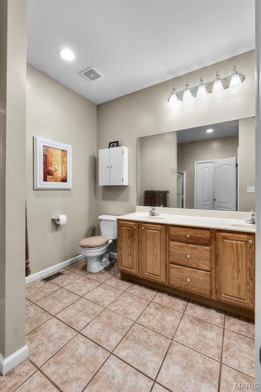 380 Stotler Way, Jackson, MO 63755 - bathroom featuring double vanity, baseboards, toilet, and tile patterned flooring
