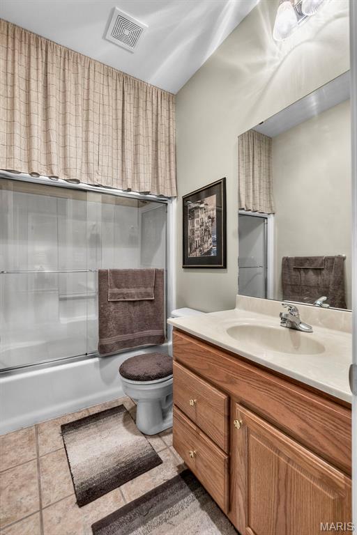 380 Stotler Way, Jackson, MO 63755 - bathroom with vanity, toilet, bath / shower combo with glass door, and tile patterned flooring