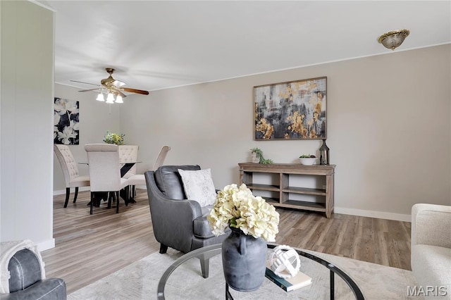 10009 Sakura Dr Unit A, Sappington, MO 63128 - living area with a ceiling fan, light wood-style floors, and baseboards