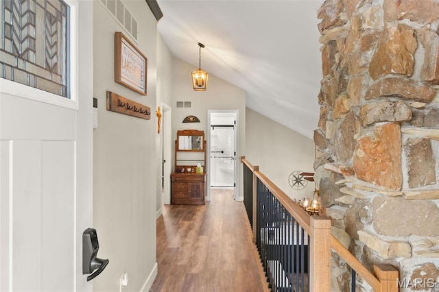 63 Portwood Meadows Rd, Rocky Mount, MO 65072 - hall with an upstairs landing, lofted ceiling, wood finished floors, and a chandelier