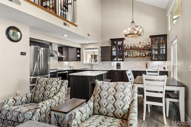63 Portwood Meadows Rd, Rocky Mount, MO 65072 - kitchen featuring open shelves, appliances with stainless steel finishes, wall chimney range hood, dark brown cabinetry, and light countertops