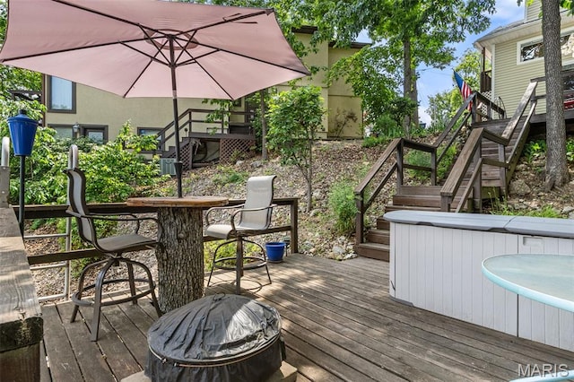 63 Portwood Meadows Rd, Rocky Mount, MO 65072 - wooden deck featuring stairway, a jacuzzi, and outdoor dining space