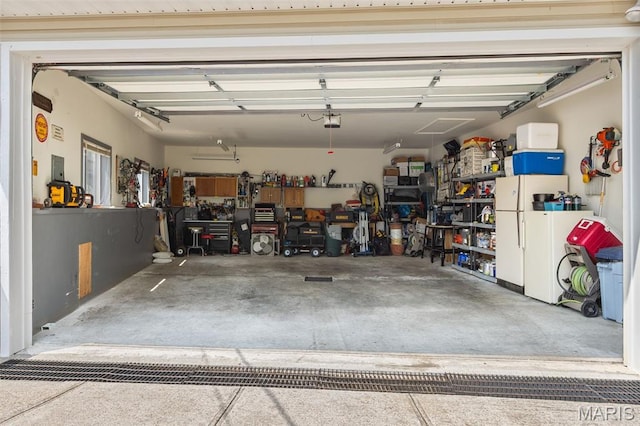 63 Portwood Meadows Rd, Rocky Mount, MO 65072 - garage featuring freestanding refrigerator and a garage door opener