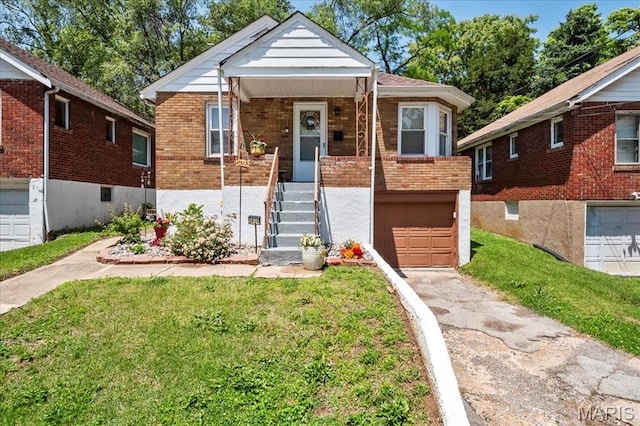 2929 Lincoln Ave, Saint Louis, MO 63121 - bungalow-style house featuring an attached garage, concrete driveway, brick siding, and a front lawn