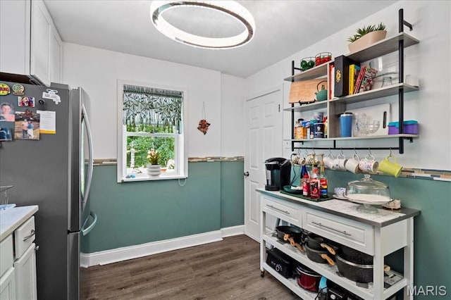 2929 Lincoln Ave, Saint Louis, MO 63121 - kitchen featuring freestanding refrigerator, dark wood-type flooring, white cabinetry, and baseboards