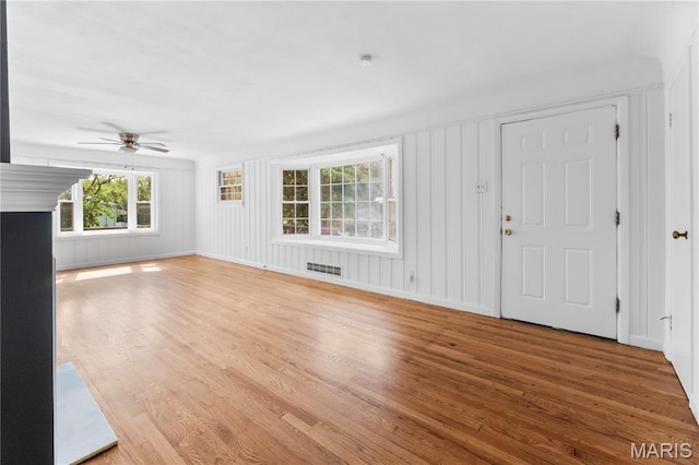 10735 Wurdack Ave, Saint Louis, MO 63114 - unfurnished living room featuring wood finished floors and ceiling fan