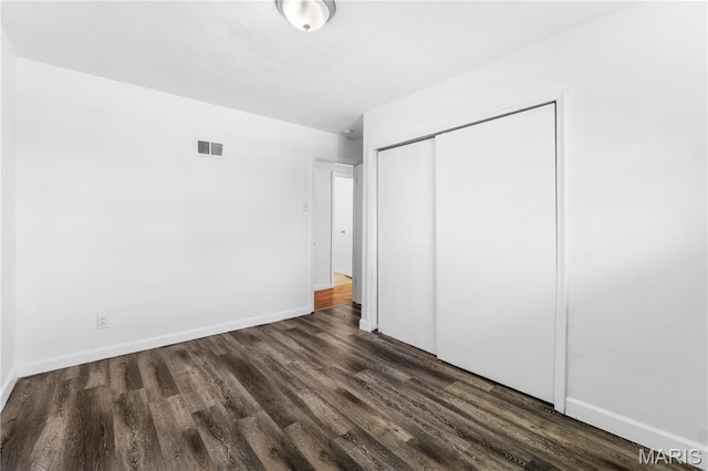 10735 Wurdack Ave, Saint Louis, MO 63114 - unfurnished bedroom featuring dark wood-style flooring and a closet