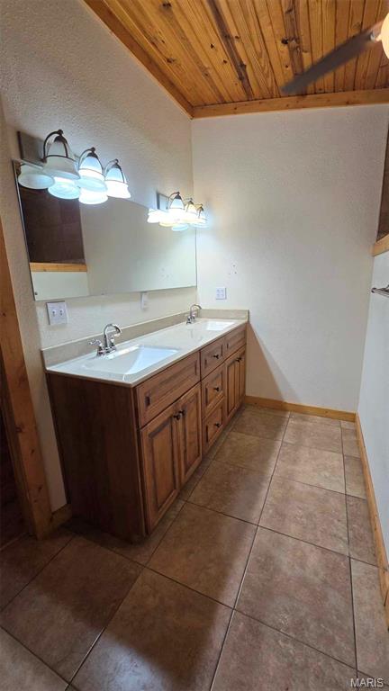 11863 Windy Curve Ln, Success, MO 65570 - bathroom featuring wood ceiling, double vanity, tile patterned floors, and baseboards