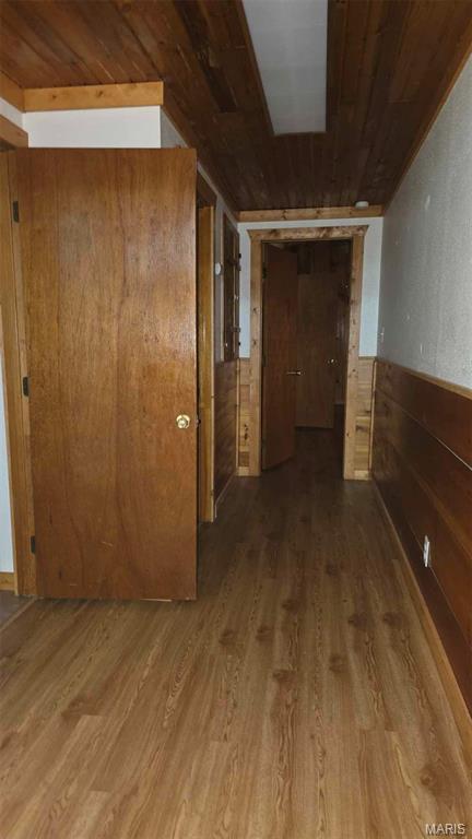 11863 Windy Curve Ln, Success, MO 65570 - hallway featuring wood ceiling, wood finished floors, wooden walls, and wainscoting