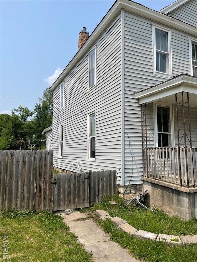 1908-19 Hope St, Hannibal, MO 63401 - view of side of home featuring a chimney