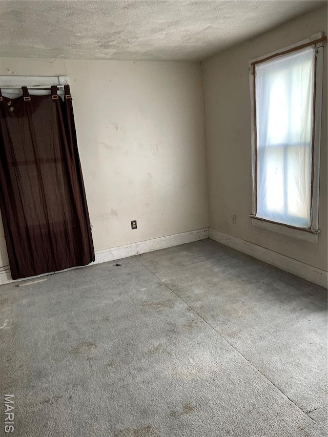 1908-19 Hope St, Hannibal, MO 63401 - spare room featuring a textured ceiling, carpet flooring, and baseboards