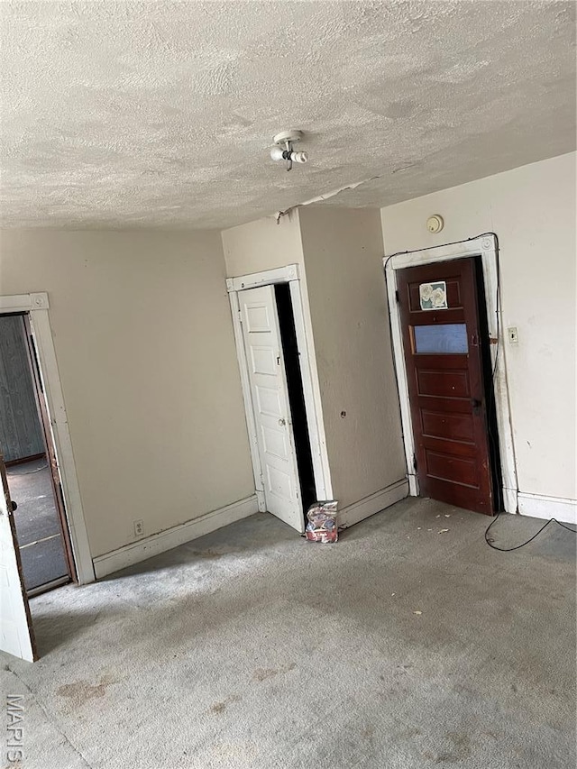 1908-19 Hope St, Hannibal, MO 63401 - unfurnished room with carpet, a textured ceiling, and baseboards
