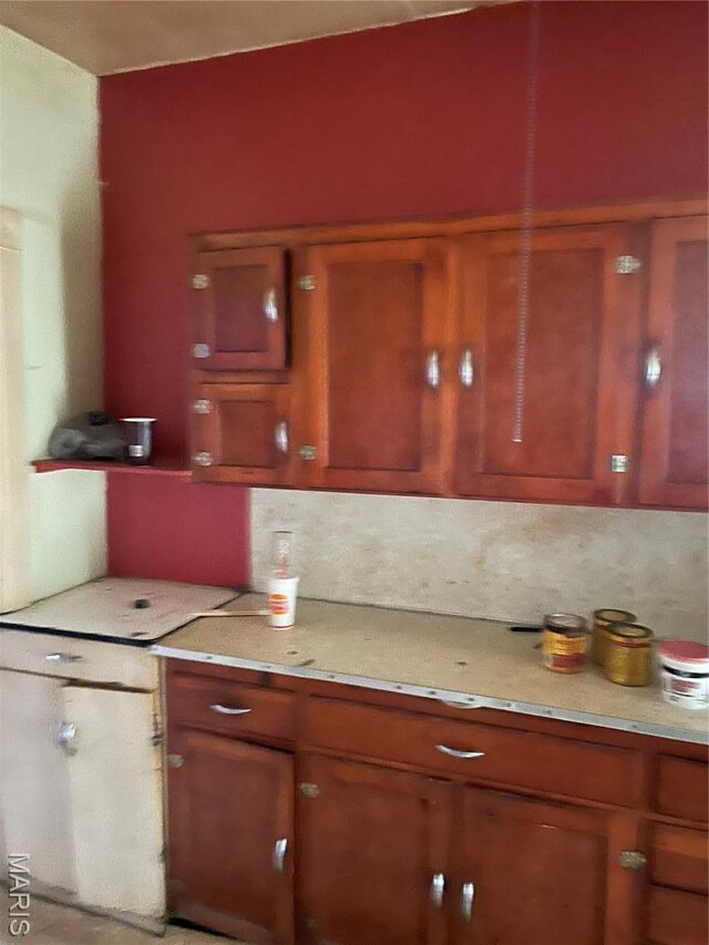 1908-19 Hope St, Hannibal, MO 63401 - kitchen with light countertops, brown cabinetry, and backsplash