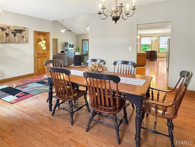 495 Oak Field Ct, Washington, MO 63090 - dining area with light wood-style flooring, a chandelier, vaulted ceiling, a ceiling fan, and baseboards