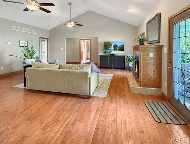 495 Oak Field Ct, Washington, MO 63090 - living area with light wood-style floors, a ceiling fan, a premium fireplace, high vaulted ceiling, and baseboards