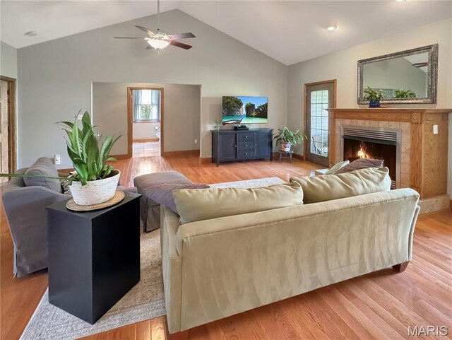 495 Oak Field Ct, Washington, MO 63090 - living area with lofted ceiling, light wood-type flooring, plenty of natural light, a tile fireplace, and ceiling fan