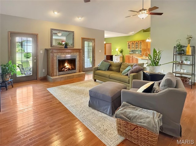 495 Oak Field Ct, Washington, MO 63090 - living area with a ceiling fan, a tile fireplace, lofted ceiling, and wood finished floors