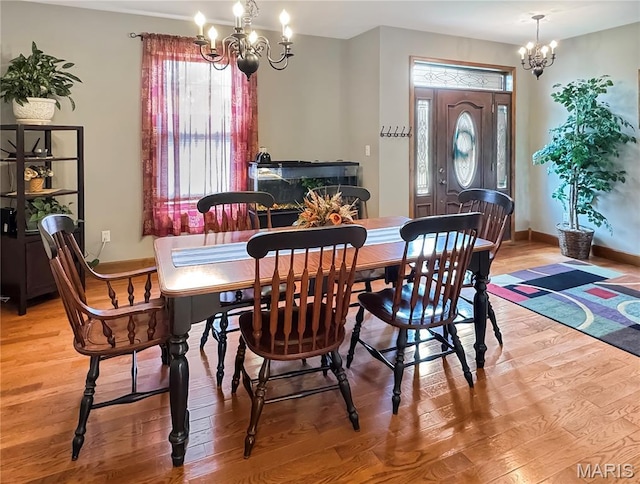 495 Oak Field Ct, Washington, MO 63090 - dining area with a chandelier, light wood-type flooring, and baseboards