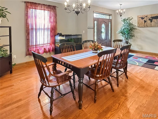 495 Oak Field Ct, Washington, MO 63090 - dining space with a chandelier, light wood-style floors, and baseboards