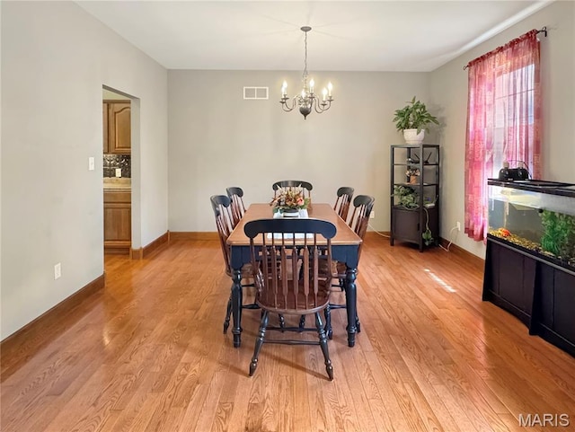 495 Oak Field Ct, Washington, MO 63090 - dining space featuring a chandelier, light wood-type flooring, and baseboards