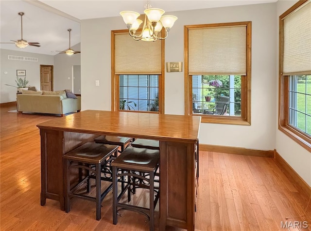 495 Oak Field Ct, Washington, MO 63090 - dining area with a chandelier, wood finished floors, baseboards, and ceiling fan