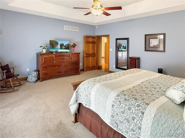 495 Oak Field Ct, Washington, MO 63090 - bedroom with light colored carpet, baseboards, ceiling fan, and a tray ceiling