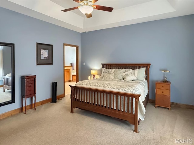495 Oak Field Ct, Washington, MO 63090 - bedroom featuring light carpet, baseboards, and a tray ceiling
