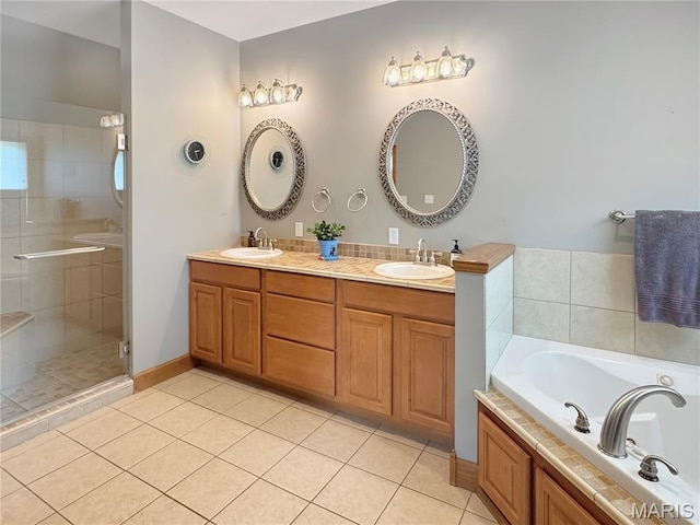 495 Oak Field Ct, Washington, MO 63090 - bathroom with double vanity, tile patterned floors, a stall shower, and a garden tub