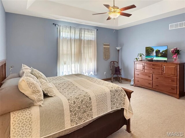 495 Oak Field Ct, Washington, MO 63090 - bedroom with a tray ceiling, light colored carpet, and ceiling fan