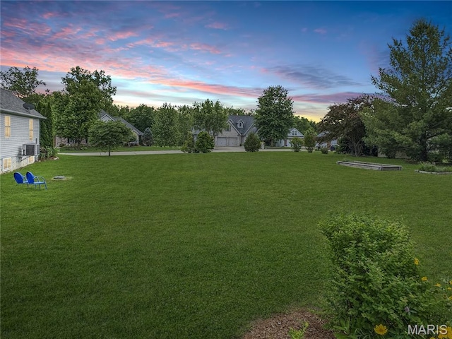 495 Oak Field Ct, Washington, MO 63090 - yard at dusk featuring a lawn