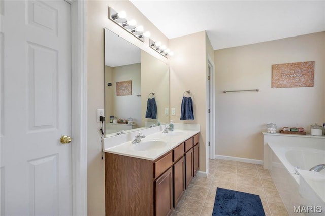 27 Brushy Brook Ct, Ofallon, MO 63366 - bathroom with a bath, double vanity, tile patterned flooring, and baseboards