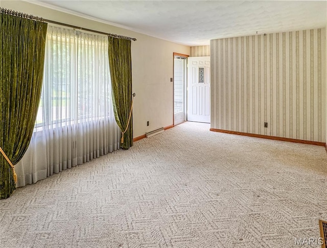 1508 3rd Pkwy, Washington, MO 63090 - empty room with baseboards, carpet floors, a baseboard radiator, and wallpapered walls