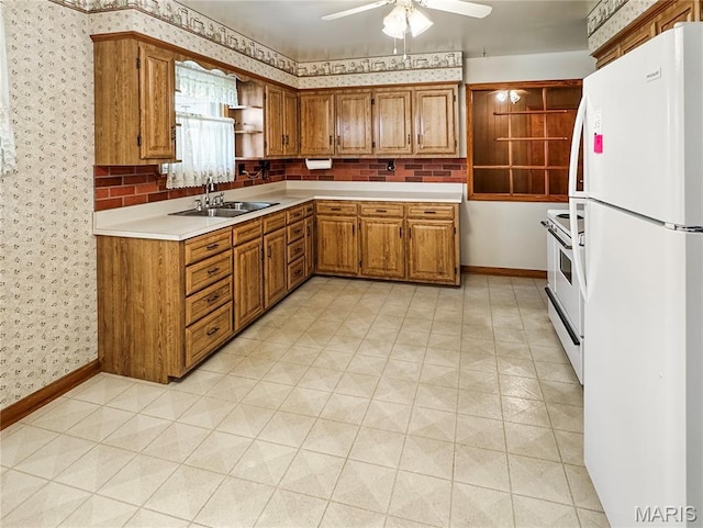 1508 3rd Pkwy, Washington, MO 63090 - kitchen with white appliances, wallpapered walls, brown cabinetry, a sink, and light countertops