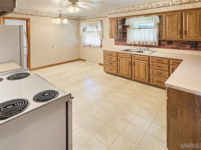 1508 3rd Pkwy, Washington, MO 63090 - kitchen featuring white appliances, a ceiling fan, wallpapered walls, light countertops, and a sink