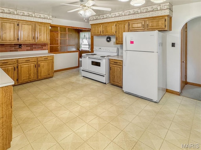 1508 3rd Pkwy, Washington, MO 63090 - kitchen with white appliances, arched walkways, ceiling fan, light floors, and light countertops