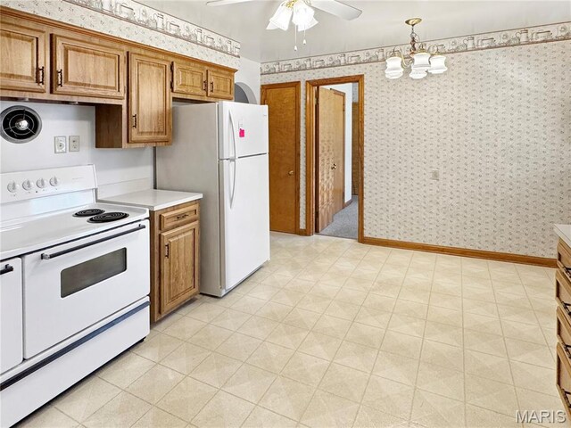 1508 3rd Pkwy, Washington, MO 63090 - kitchen featuring white appliances, brown cabinets, light countertops, wallpapered walls, and a ceiling fan